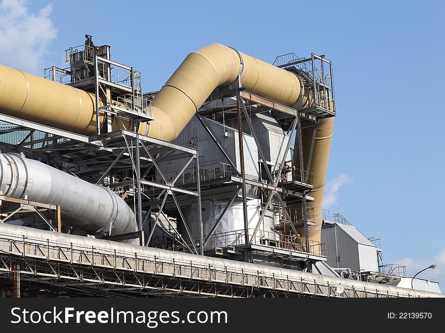 Industrial pipelines against blue sky