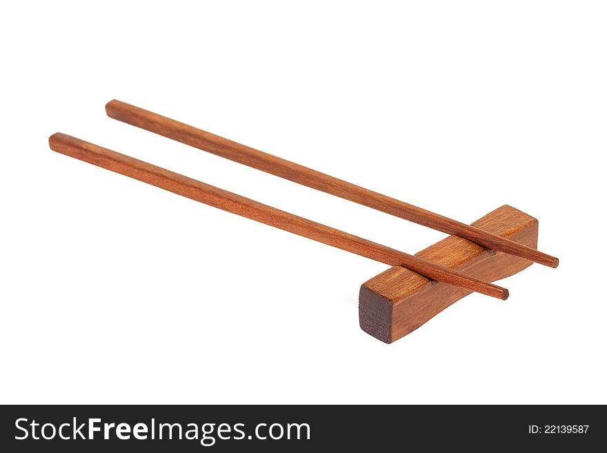 Wooden chopsticks on a stand, on a white background
