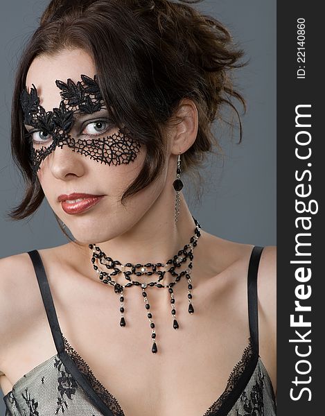 Attractive young woman in elegant lace mask and accessories. Attractive young woman in elegant lace mask and accessories