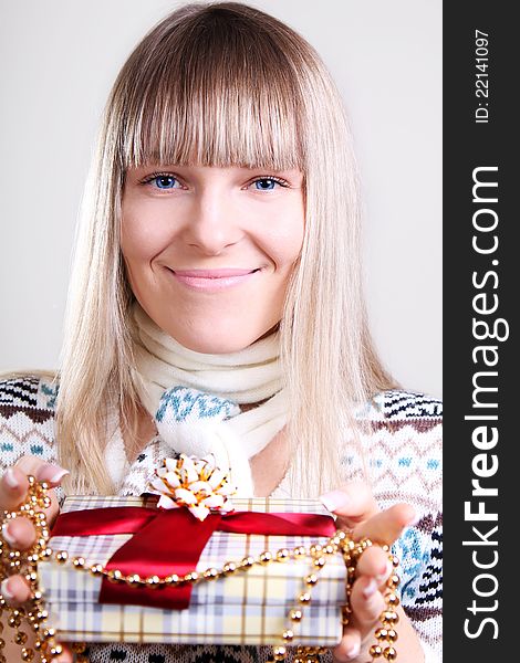 Beautiful young smiling woman with Christmas gift. Beautiful young smiling woman with Christmas gift