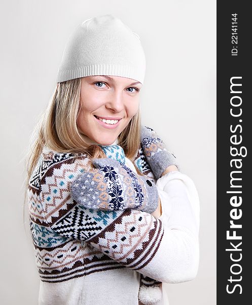 Beautiful young smiling woman in a knitted sweater. Beautiful young smiling woman in a knitted sweater