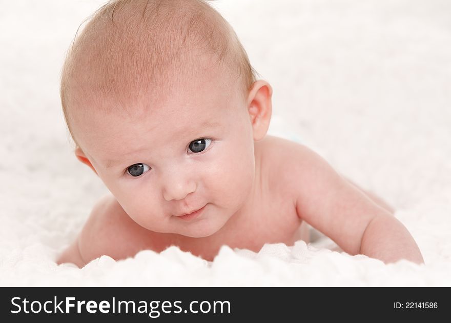 Baby girl lying on white bed. Baby girl lying on white bed