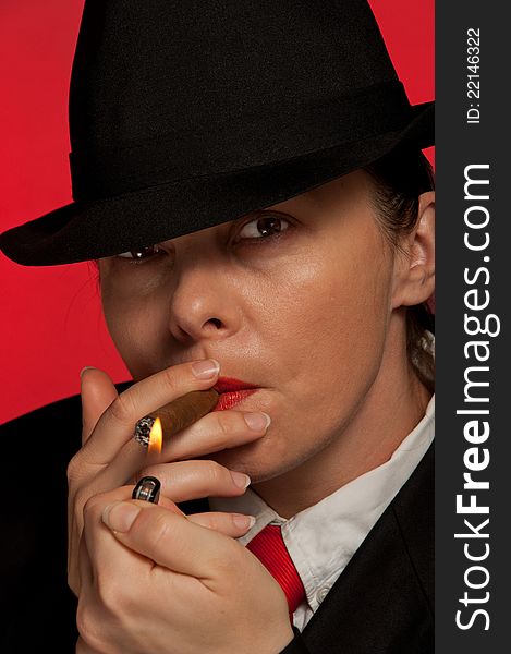 Beautiful woman with a cigar and a hat. Beautiful woman with a cigar and a hat