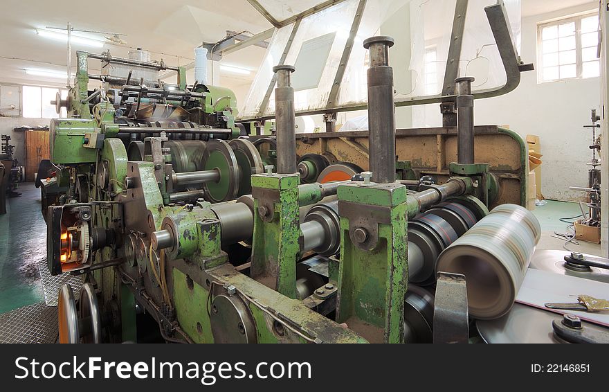 Details of a printing machine inside factory.