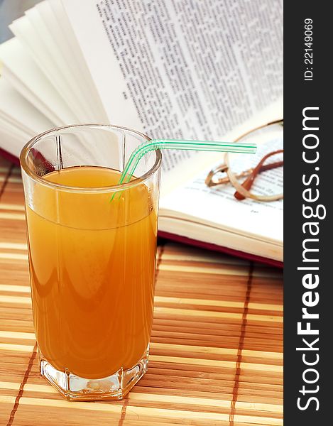 Multifruit juice with book and glasses