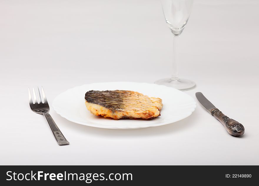 Fish in white plate . Fish in white plate .