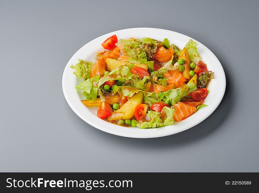 Salmon salad with potato, tomato and pea