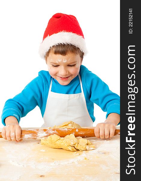 Smiling little boy kneading the dough for Christmas cooking, isolated on white. Smiling little boy kneading the dough for Christmas cooking, isolated on white