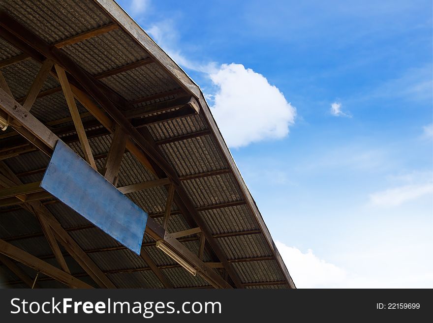 Blank sign and warehouse on blue sky background