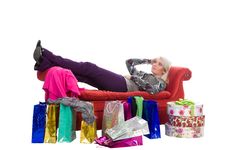 Woman Lying On A Red Couch, Shopping Bags Stock Images Woman Lying On A Red Couch, Shopping Bags Stock Images