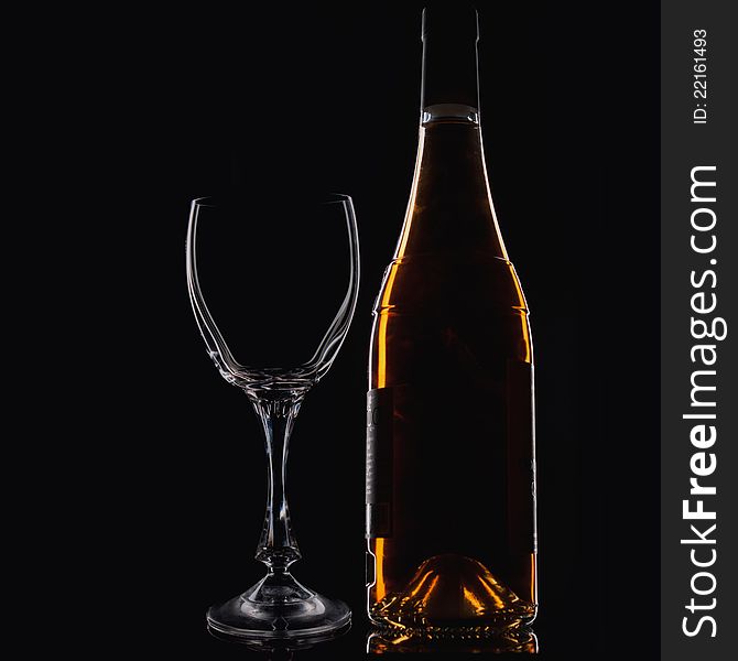 Wine Glass  and Wine Bottle over dark background