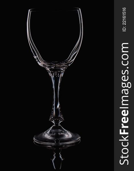 Single empty wine glass over black background,low light