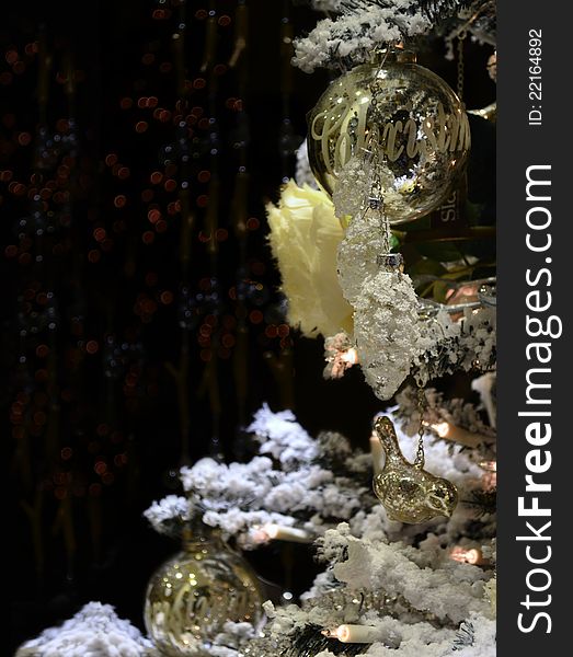 Christmas festive decorations with gold balls, lights and snowy pine branches with black background copy space. Christmas festive decorations with gold balls, lights and snowy pine branches with black background copy space