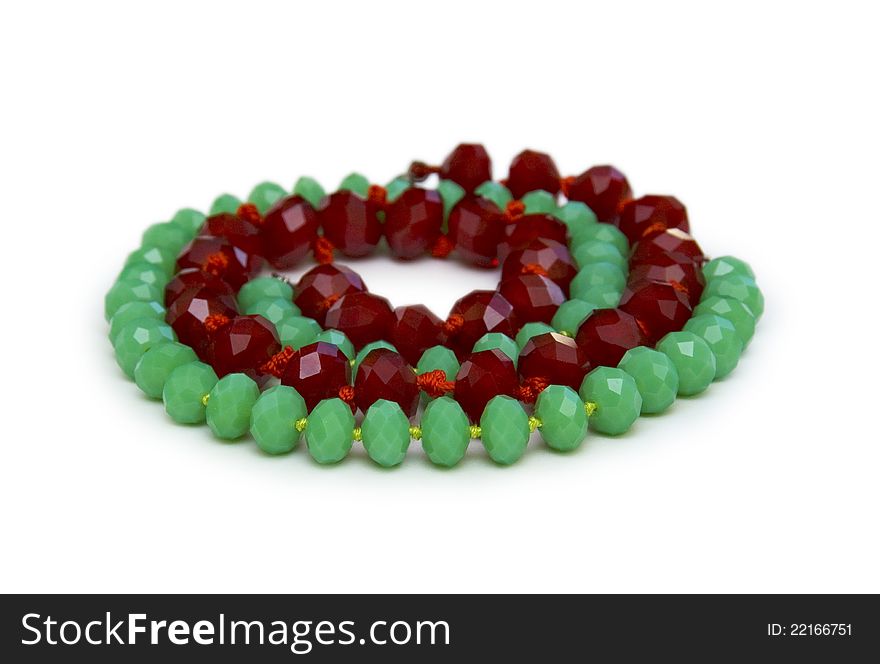 Necklace made of green and red beads isolated on white. Necklace made of green and red beads isolated on white