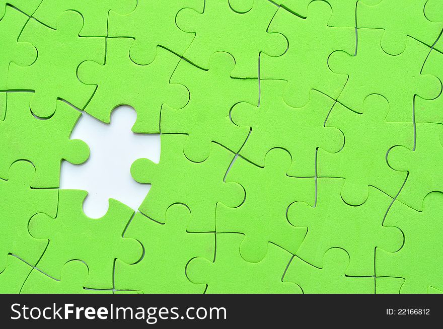 Green jigsaw puzzle with one missing piece. Green jigsaw puzzle with one missing piece