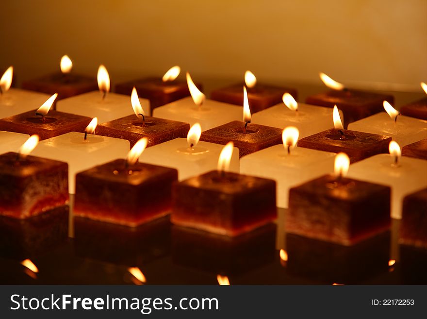 Group of brown and white candles creating spa atmosphere. Group of brown and white candles creating spa atmosphere