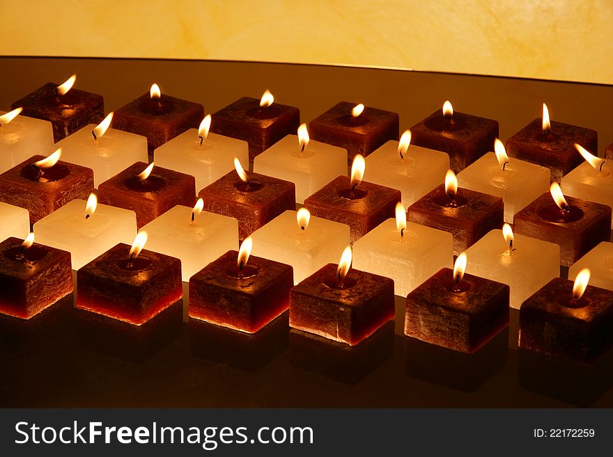 Group of brown and white candles creating peaceful atmosphere. Group of brown and white candles creating peaceful atmosphere