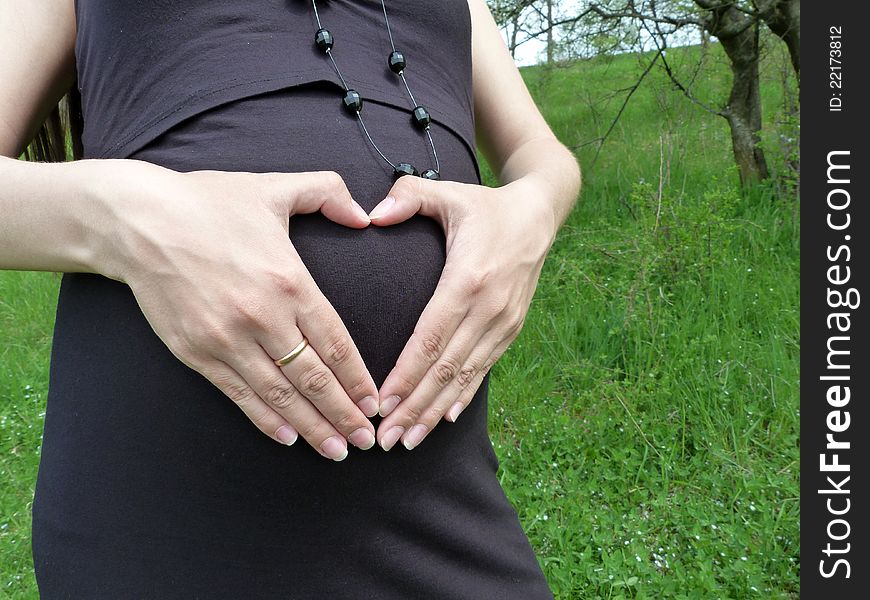 Beautiful pregnant devusha walks in spring park