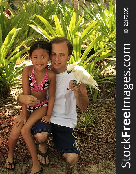 Little girl with dad holding a bird. Little girl with dad holding a bird