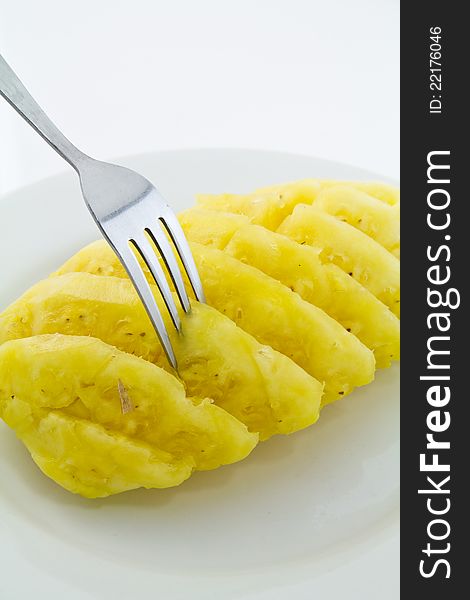 Pineapple on white dish with fork. Pineapple on white dish with fork