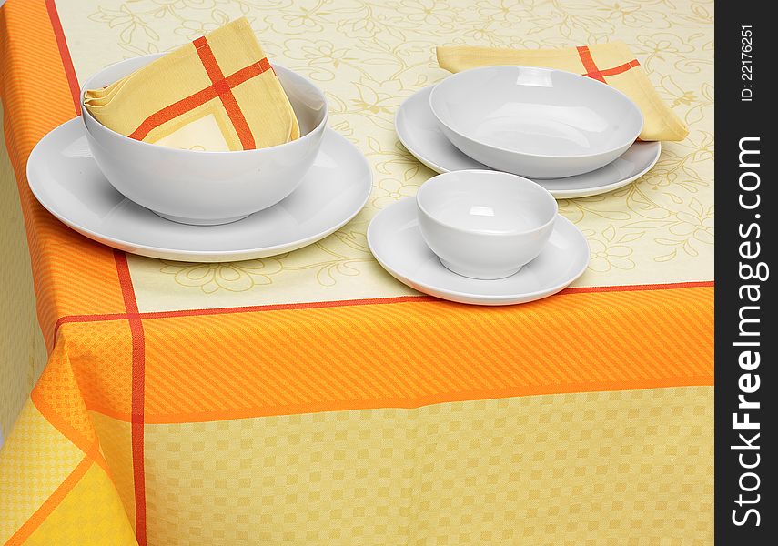 White plates and cups on table set. White plates and cups on table set