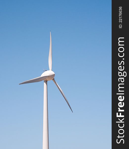 Wind turbine against a blue sky. Wind turbine against a blue sky.