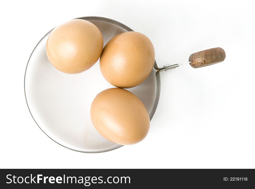 Eggs in kitchenware on white background