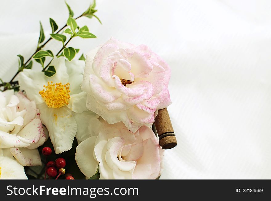 Pink roses and white camellias in a basket on white background