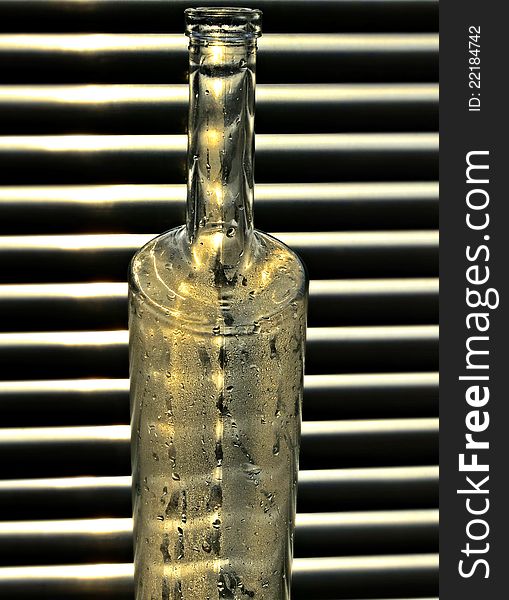 Glass bottle on window background