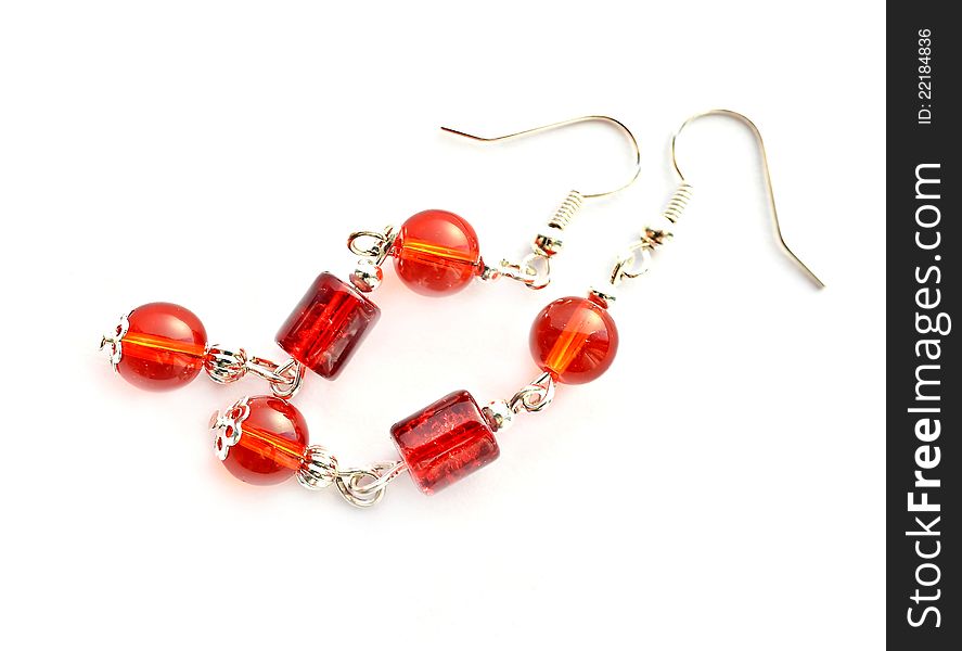 Red earrings on white background