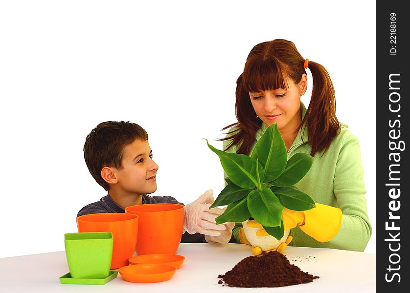 Mother and her son (boy, kid) planting a flower  isolated on a white background with different color flowerpots