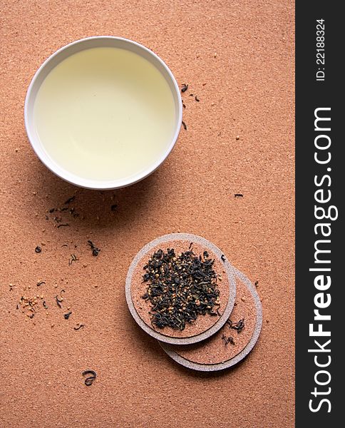 A bowl of green tea with light brown background.