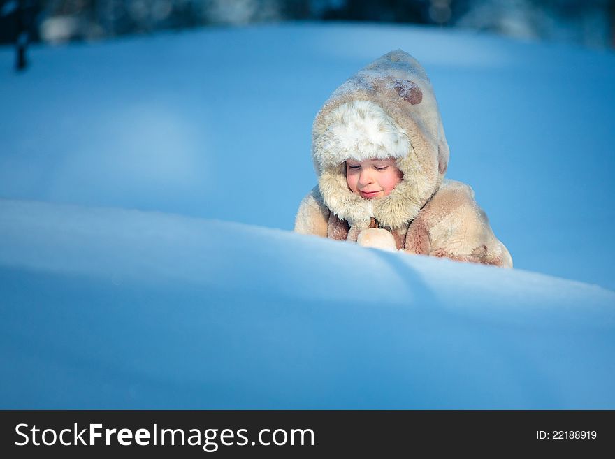 Portrait of a little boy in winter forest