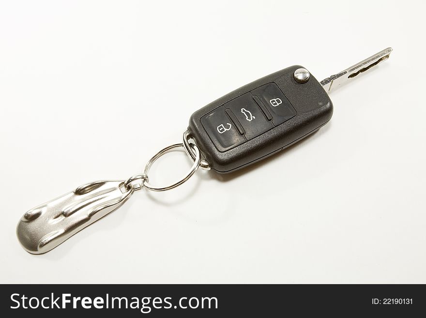 Shaped keychain silver car with the keys to a car. Shaped keychain silver car with the keys to a car