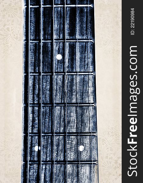 Acoustic guitar neck fingerboard on textured background