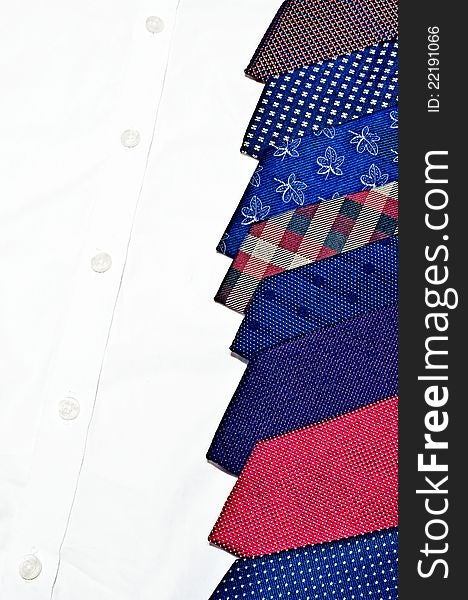 Colorful neck ties stack on white buttoned shirt