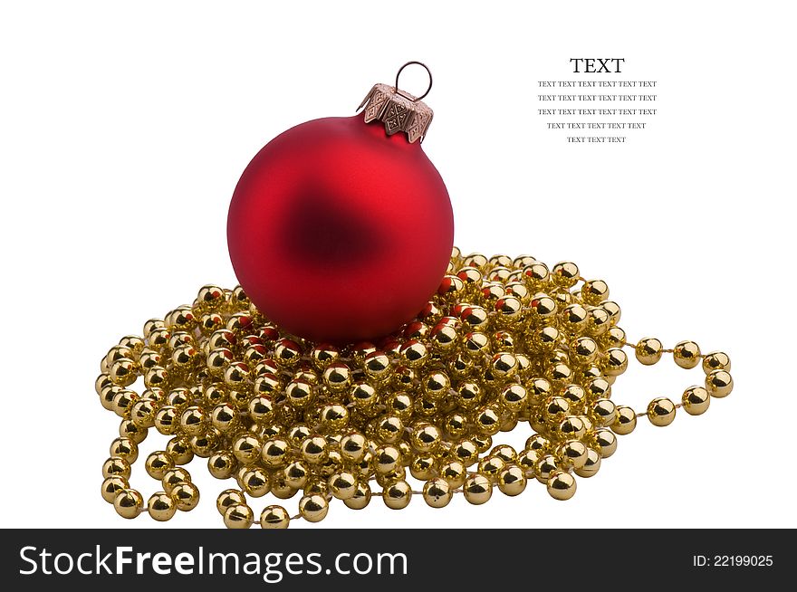 Christmas red sphere on a gold ornament for a pine