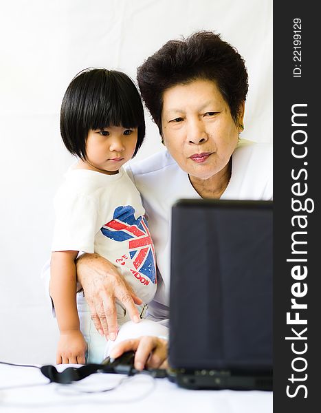 Old women with girl using laptop computer for online. Old women with girl using laptop computer for online