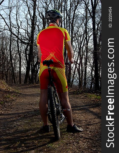 Photo of mountain biker in sporting costume with helmet. Photo of mountain biker in sporting costume with helmet.