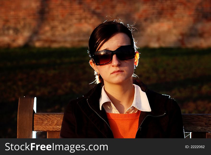 Photo of pretty female in sunshine light with cell phone. Photo of pretty female in sunshine light with cell phone.