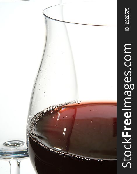 Two wine glasses with red wine close up on grey background