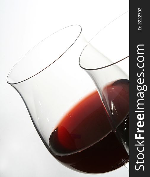 Two wine glasses with red wine close up on grey background