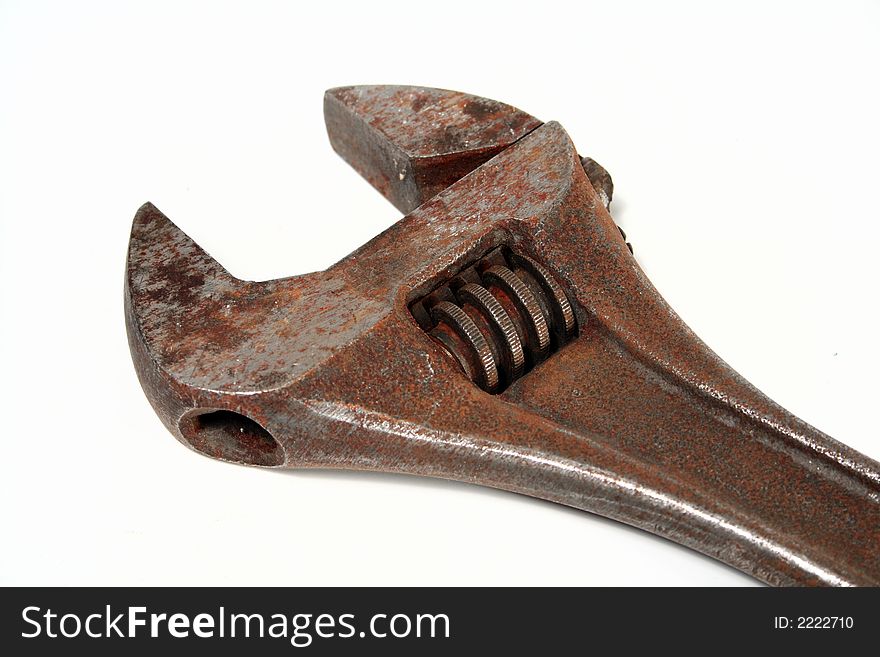 A rusty old monkey wrench isolated on white background. A rusty old monkey wrench isolated on white background.