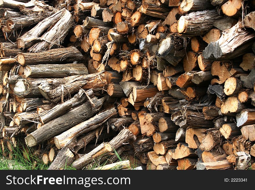 Several cords of wood ready to be used in the winter for fire wood in a wood burning stove. Several cords of wood ready to be used in the winter for fire wood in a wood burning stove.