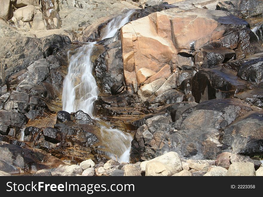 A cascading waterfall in the Rocky Mountain National Park in Colorado. A cascading waterfall in the Rocky Mountain National Park in Colorado.