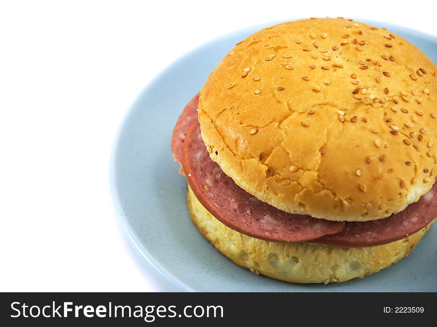 Beautiful hamburger on a blue plate on a white background