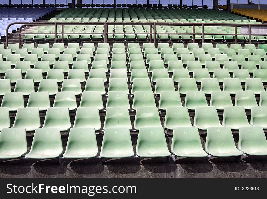 Many Empty Seats In Rows In An Outdoor Stadium. Many Empty Seats In Rows In An Outdoor Stadium