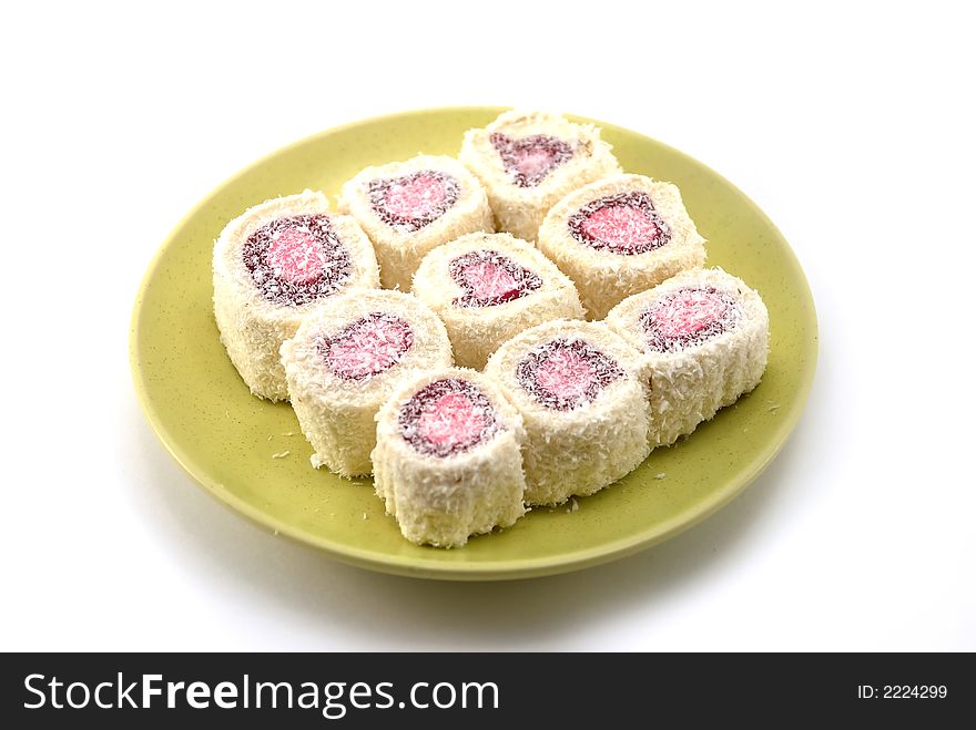 Beautiful fruit candy with a stuffing on a plate on a white background