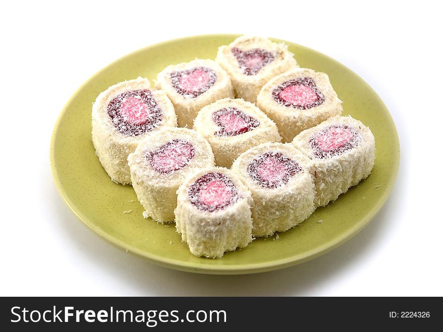 Beautiful fruit candy with a stuffing on a plate on a white background