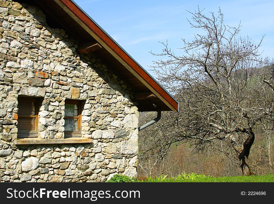 An old farm in the french countryside with an old tree. An old farm in the french countryside with an old tree